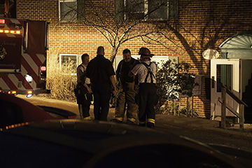 Firefighters outside a building in the Autumn Ridge apartment complex in the Fenton area, where 40 people were evacuated because of a small fire and heavy smoke.