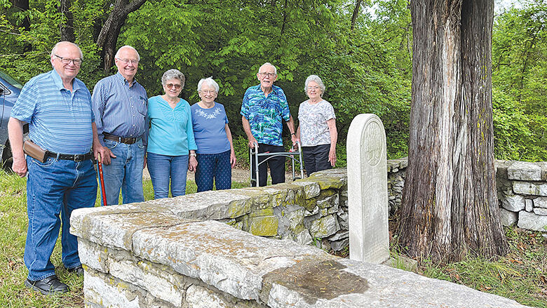 Members of the Jeude family at the gravesite of their ancestors, Herman, pictured at left, and Agnes Jeude. From left, Dennis Feldkamp, Al Jeude, Sue Jeude, Bernice Jeude Feldkamp, Bill Jeude and Elaine Jeude.