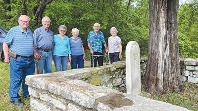 Members of the Jeude family at the gravesite of their ancestors, Herman, pictured at left, and Agnes Jeude. From left, Dennis Feldkamp, Al Jeude, Sue Jeude, Bernice Jeude Feldkamp, Bill Jeude and Elaine Jeude.
