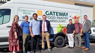 Executive Director Patrick McKelvey, fourth from left, with Gateway Food Pantry Board of Director members, from left, Lori Crutchley, Ed Fitzhenry, Adam Lambay, Holly Lincoln, Don Bojrab and Chad Dickemper in front a van with the pantry’s new name on Ju...