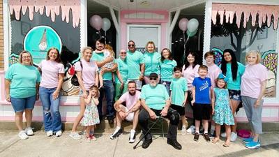 Family members take part in a grand opening of GiGi’s Ice Cream and Treats, 110 N. Main St., De Soto, on June 17.