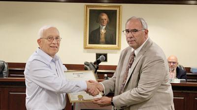 Steven Crawford, left, accepts a proclamation from County Executive Dennis Gannon.