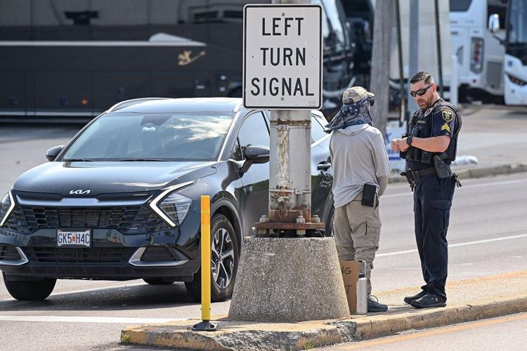 Sgt. Chris Hobbs, right, of the Columbia Police Department issues a warning