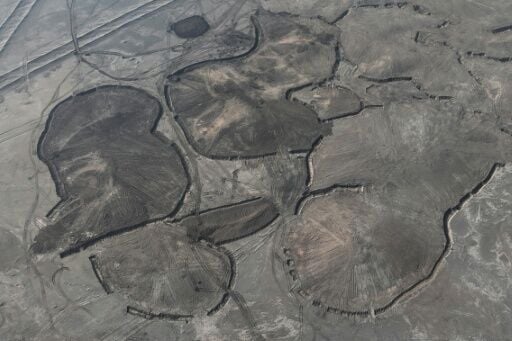 Between the cities of Nasiriyah and Samawah, not far from ancient Sumerian ruins, labourers are working hard to stabilise the soil by applying a layer of moist clay
