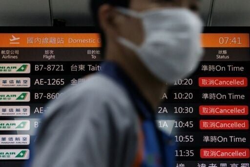 A flight information display board shows cancelled flights at Taipei's Songshan Airport. More than 100,000 passengers were expected to be affected by flight disruptions as a result of China's military drills