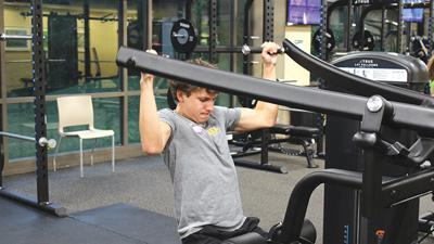Sam Wienstroer, a junior at Eureka High School, uses the lat pulldown weight machine on Aug. 6 at the Timbers of Eureka Recreation Center.