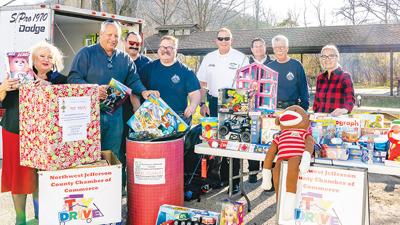 Northwest Jefferson County Chamber of Commerce members and local firefighters collect toys at the 2021 toy drive.