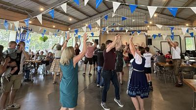 People dance to the Fliegerlied played by the Deutschmeister Brass Band on Sept. 13 during Oktoberfest at Donau Park in House Springs.