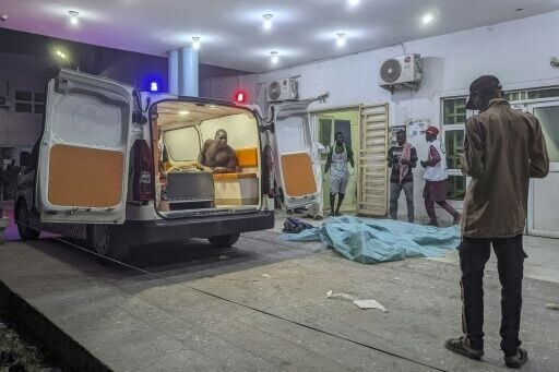 An injured man looks out of an ambulance at a hospital in Maiduguri