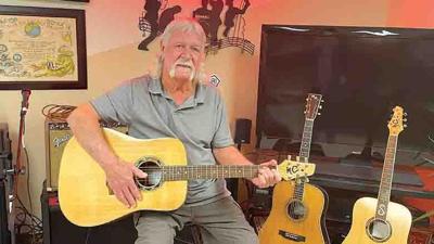 Michael Schuerman, 74, holds the guitar he is currently most proud of.