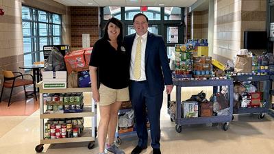 Karen Fay, Arnold Parks and Recreation Department procurement specialist, and Patrick McKelvey, Gateway Food Pantry executive director, on Nov. 17 gather donations made at the Arnold Recreation Center during the Feed the Masses campaign.