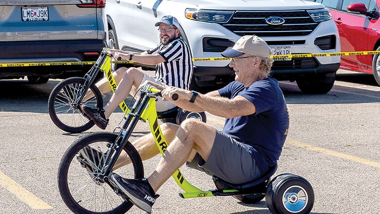 From left, Andrew Webster of Festus and Dan Abts, president elect of the Rotary Club of Festus-Crystal City, face off in the Adult Big Wheel Tricycle Races during Twin City Days.