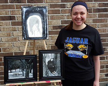 Mackenzie Cook with her three pieces of art that recently were selected for a national exhibit.