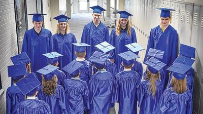 The five graduating TCCA seniors meet with the academy’s kindergarten graduates in the school hallway.