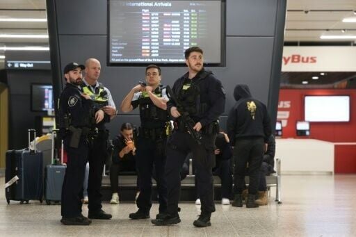 Police wait at Melbourne airport for the arrival of Australian women and children returning from Syrian camps