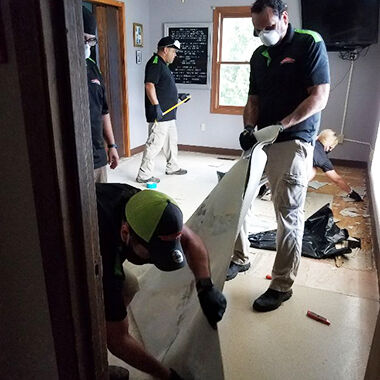 Crews work to clean up after flooding at the Jefferson County Rescue Mission in Pevely.