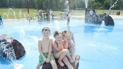 From left, Tyler Thornton, 6, Lux Thornton, 5, and Lacey Thornton, 3, of Pevely enjoy the Bay of Naples Splash Zone.