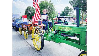 Mike Koch with the certificate proclaiming his tractor “most patriotic parade entry.”