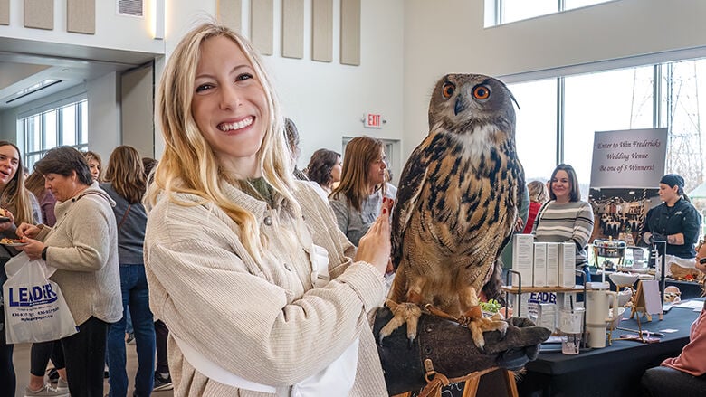 Party Paws Mobile Zoo lets Chelsey Flieg from Imperial try to hold the owl that delivers wedding bands for wedding ceremonies.