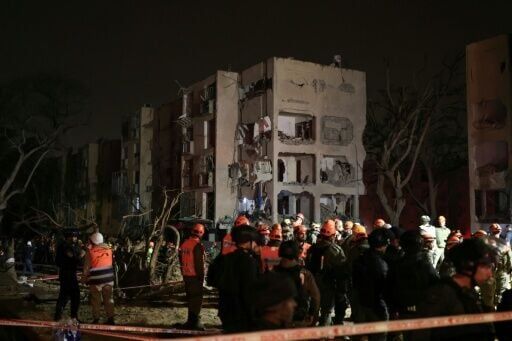 First responders inspect the site of an Iranian missile strike in the Israeli town of Arad on March 22, 2026