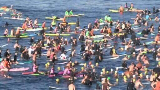 Hundreds of Bondi Beach surfers and swimmers pay tribute to shooting victims