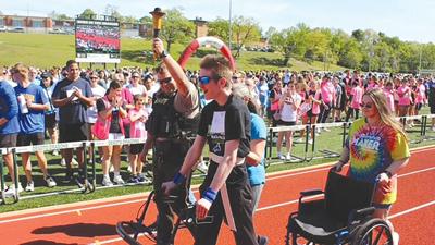 Athlete Shawn Smith of Pony Bird walks the track on April 21 during the Special Olympics Track and Field opening ceremony at De Soto High School.