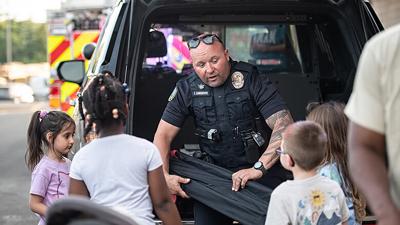 Arnold Police Officer Josh Lambrich talks with Fox C-6 students and parents at the 2025 Fox C-6 School District Back to School Expo.