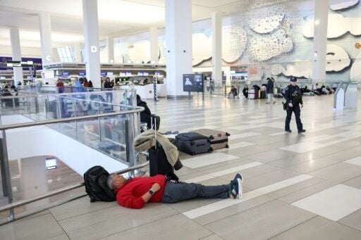 Travelers waiting inside Terminal B at LaGuardia Airport following the collision