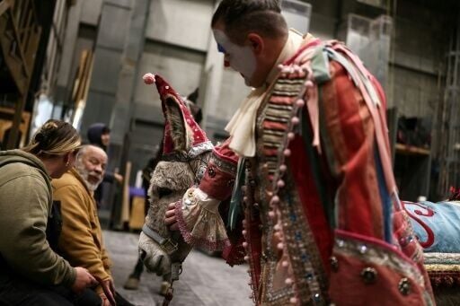 Actor Gregory Warren, who plays Parpignol, pats Wanda the donkey as they wait backstage ahead of their cue call in "La Boheme" at New York's Metropolitan Opera