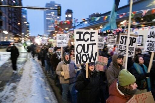 Demonstrators march during the nationwide 'Stop ICE Terror' rally in Minneapolis on January 20, 2026