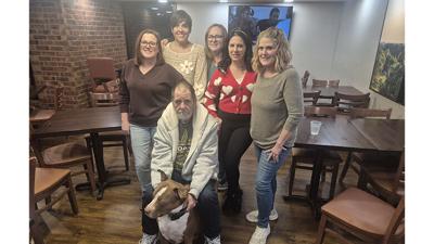 Back from left, Michelle Lamb, Danielle Gherardini, Vanessa Williams Hathaway, Pamela Sophie and Nancy Hakala-King formed a group to help Dan Cothern and his dog, Bentley, find a home. The group has collected money to pay for Cothern and Bentley to stay...