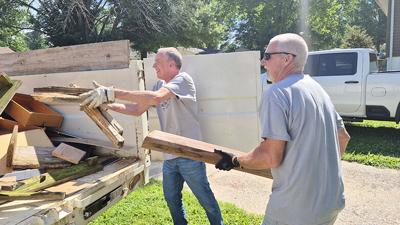 Gene Mattler, left, and Dave Dugan load debris from a home in Pevely into a truck. Healing Homes Ministry repaired 10 homes in southern Jefferson County from June 15-19.