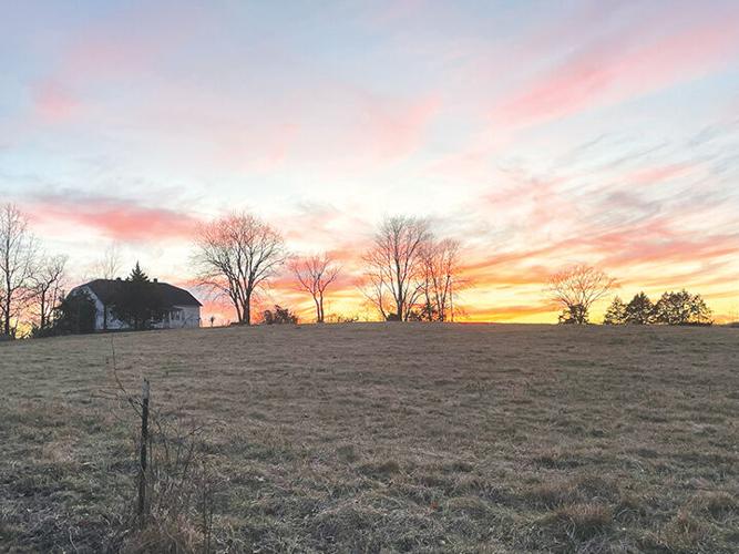 The sun sets over the original Harness Farms house in 2021.