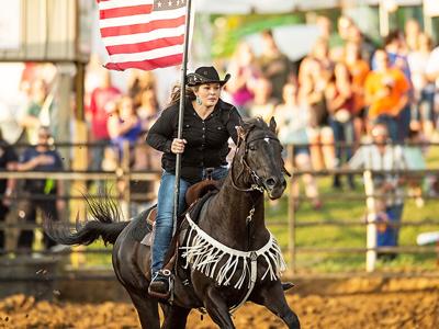 Heather Corley of Hillsboro carried the American flag at the 2019 Jefferson County Rodeo.