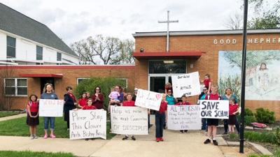 Protesters at Good Shepherd Catholic School in HIllsboro, which is set to close at the end of this school year.