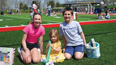 From left, Chloe Mantler, 11, Carly Mantler, 3, and Caleb Mantler, 9, all from Imperial, with prizes they won at the Arnold Chamber of Commerce’s Eggstravaganza.