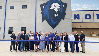 Staff attend the ribbon-cutting at Northwest High School’s new multipurpose building.