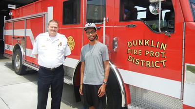 Dunklin Fire Protection District Assistant Chief Mike McClain with Austin Hill, a Herculaneum resident lauded for his quick actions in helping a disoriented woman get out of a burning house in a July 16 incident.