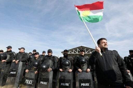 A protester holds a Kurdish flag at a demonstration outside the United Nations office in Arbil, the capital of Iraq's northern autonomous Kurdish region, in January 2024