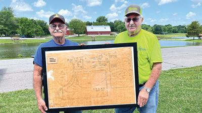 The Peterein brothers Wendell, left, and Glennon with a map of their family farm, purchased by the city of Festus in 1981 to form West City Park (now Larry G. Crites Memorial Park).