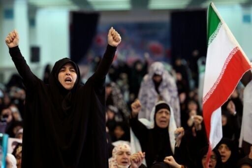 Iranian Shia women shout slogans during Eid al-Fitr prayers