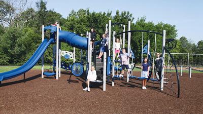 Brennan Woods Elementary School students explore the school’s new playground.