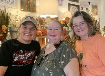 From left, Lara Dane, Linda Visner and Michelle Hohmeier with Tree of Life Home, Art & Vintage Market.