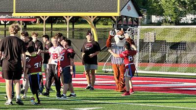 Fox High School’s mascot, Arnold the Fox, celebrates a touchdown on May 7 during an all-inclusive flag football game that was held to collect money for the school’s Best Buddies program.