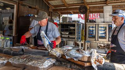 Behind every plate of barbecue is a hardworking crew keeping the food coming at the Backstoppers BBQ.