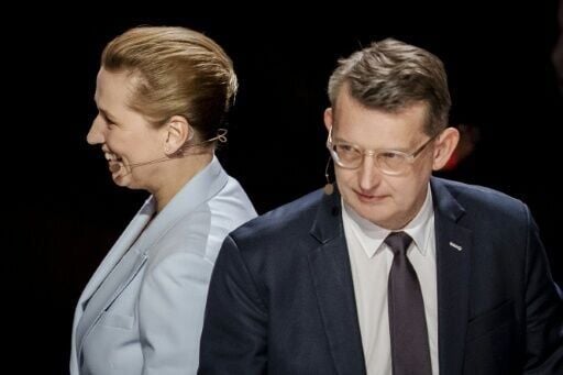 Danish Prime Minister Mette Frederiksen (left) passes Venstre leader Troels Lund Poulsen during an election debate