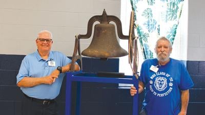 Class of 1972 alumni Michael McGriff, left, and Mark Nelson worked to bring the old school bell back to Maple Grove Elementary.
