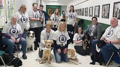 Canine Companion Therapy Program handlers and their dogs.