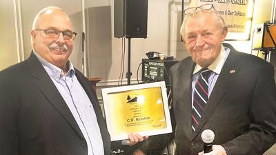 CR Kersten, left, receives the Northwest Jefferson County Chamber of Commerce’s Community Service Award on Nov. 4 from chamber president Danny Tuggle.