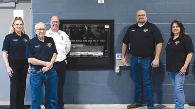 From left, Big River Ambulance District board member Brittney Moore, treasurer James Terry, Chief Scott Fisher, chairman Josh Williams and vice chairman Janet Taylor with the new Safe Haven Baby Box at House 1 in Cedar Hill.